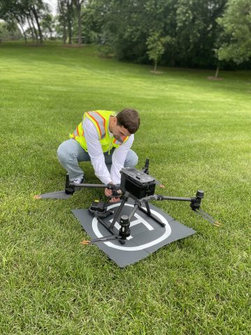 Drone pilot preparing drone for flight — part of our standard safety and setup process