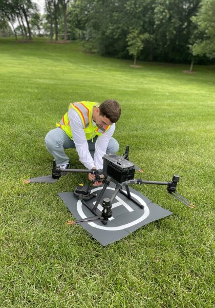Drone pilot preparing drone for flight — part of our standard safety and setup process